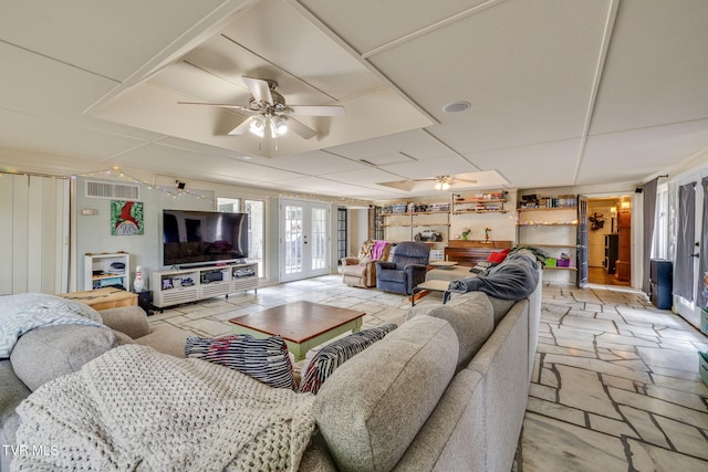 1605 Woodmont Dr, Johnson City, TN 37601 - living room featuring a ceiling fan, french doors, stone tile floors, and a drop ceiling