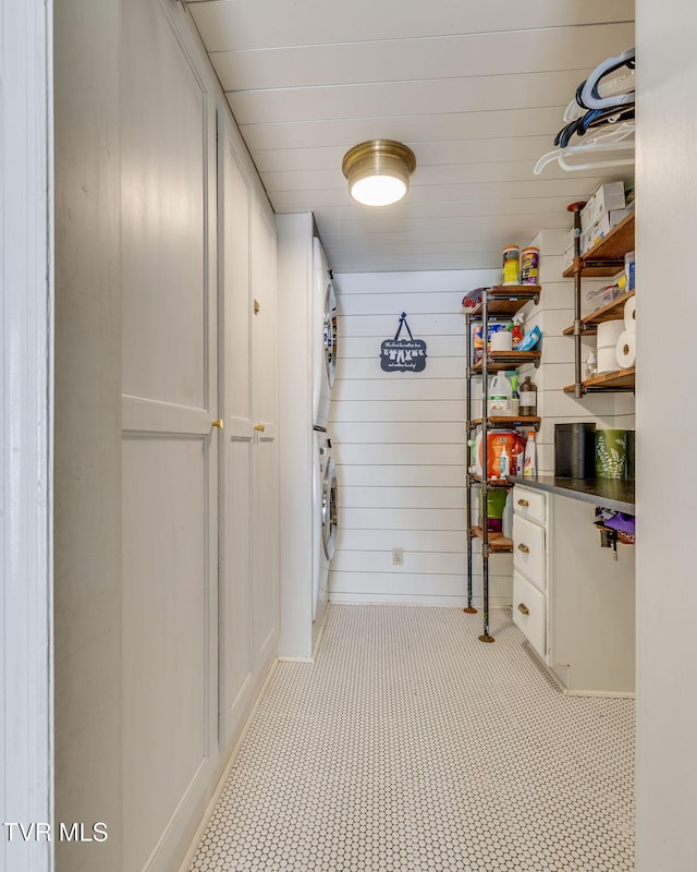 1605 Woodmont Dr, Johnson City, TN 37601 - laundry room with stacked washer / dryer and wooden walls