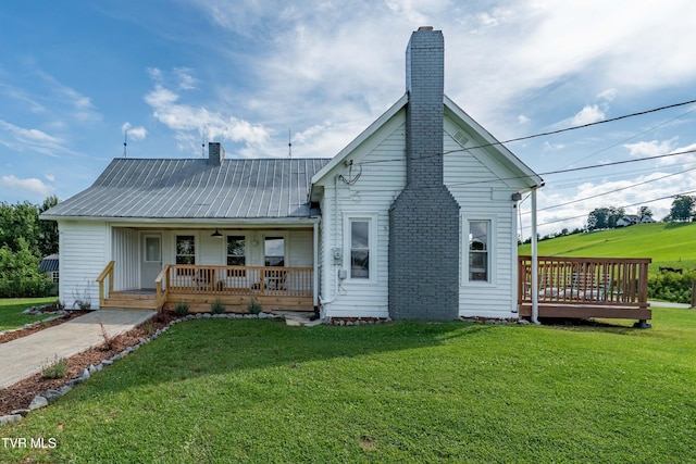 654 W Valley Dr, Kingsport, TN 37664 - back of house with covered porch, a chimney, a yard, and a metal roof
