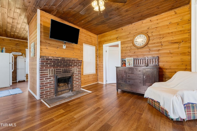 654 W Valley Dr, Kingsport, TN 37664 - bedroom with freestanding refrigerator, wooden ceiling, wood walls, wood finished floors, and a brick fireplace