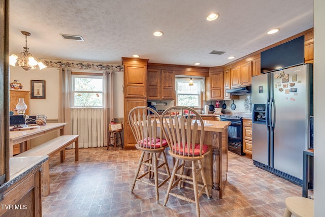 2129 Philon Dr, Kingsport, TN 37660 - kitchen with stainless steel fridge with ice dispenser, black / electric stove, under cabinet range hood, plenty of natural light, and a textured ceiling