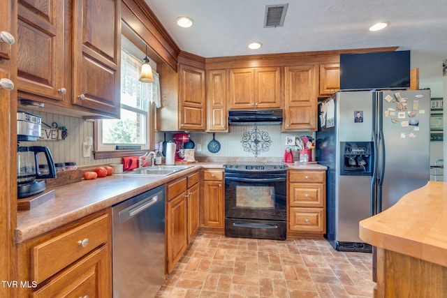 2129 Philon Dr, Kingsport, TN 37660 - kitchen with appliances with stainless steel finishes, under cabinet range hood, brick patterned floors, brown cabinets, and light countertops