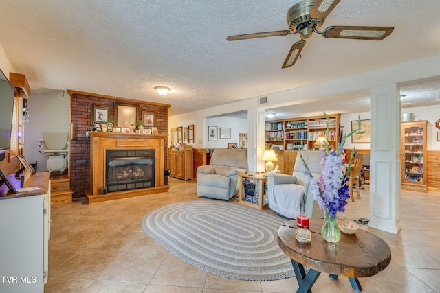 2129 Philon Dr, Kingsport, TN 37660 - living room with a textured ceiling, ceiling fan, a brick fireplace, and light tile patterned floors