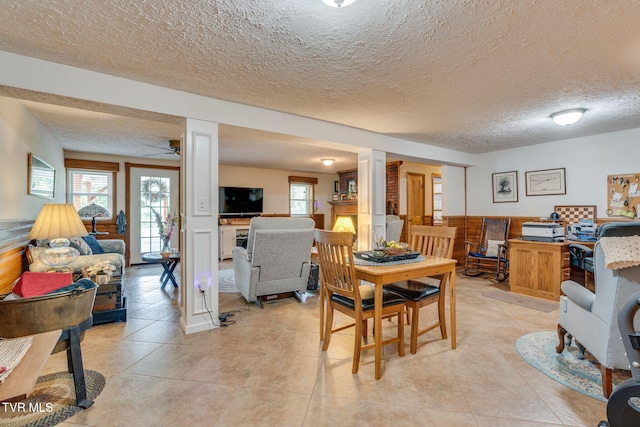 2129 Philon Dr, Kingsport, TN 37660 - dining area featuring decorative columns, a textured ceiling, a ceiling fan, and light tile patterned floors