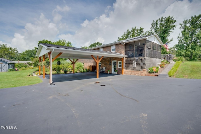 2129 Philon Dr, Kingsport, TN 37660 - view of front of house with a sunroom, driveway, a front lawn, and brick siding