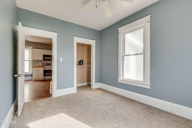 1234 E Center St, Kingsport, TN 37660 - empty room featuring light carpet and a ceiling fan