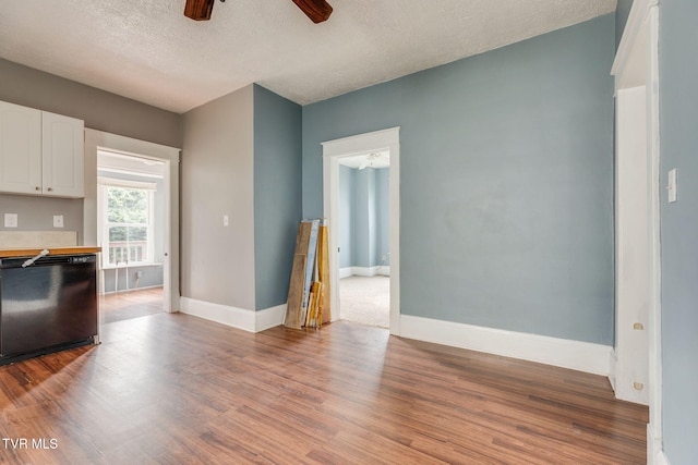 1234 E Center St, Kingsport, TN 37660 - kitchen with black dishwasher, white cabinetry, a ceiling fan, wood finished floors, and a textured ceiling