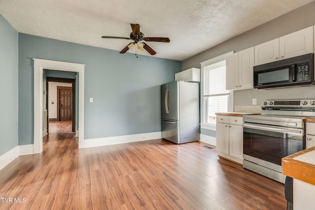 1234 E Center St, Kingsport, TN 37660 - kitchen with stainless steel appliances, white cabinets, ceiling fan, light wood finished floors, and a textured ceiling
