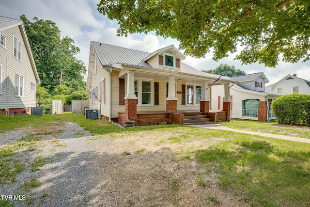 1234 E Center St, Kingsport, TN 37660 - view of front of house with covered porch, a metal roof, and a front yard