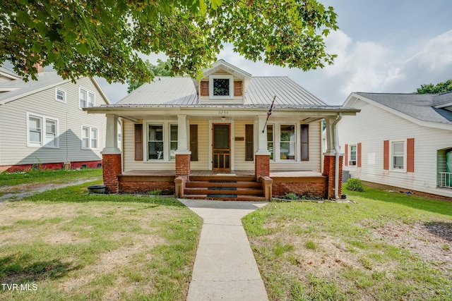 1234 E Center St, Kingsport, TN 37660 - bungalow with a porch, a metal roof, and a front yard