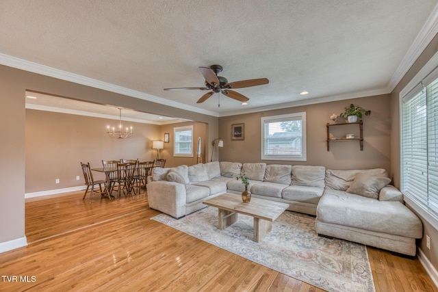 605 Dickerson St, Kingsport, TN 37665 - living area with light wood-type flooring, ceiling fan, a chandelier, a textured ceiling, and ornamental molding