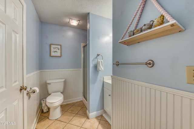 605 Dickerson St, Kingsport, TN 37665 - full bath with a wainscoted wall, tile patterned flooring, a stall shower, a textured ceiling, and vanity