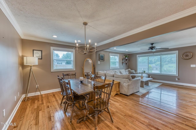 605 Dickerson St, Kingsport, TN 37665 - dining area with light wood-type flooring, a textured ceiling, a chandelier, crown molding, and recessed lighting