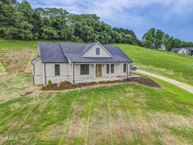77 Sunset Rd, Johnson City, TN 37615 - modern farmhouse featuring a porch, a front yard, and roof with shingles