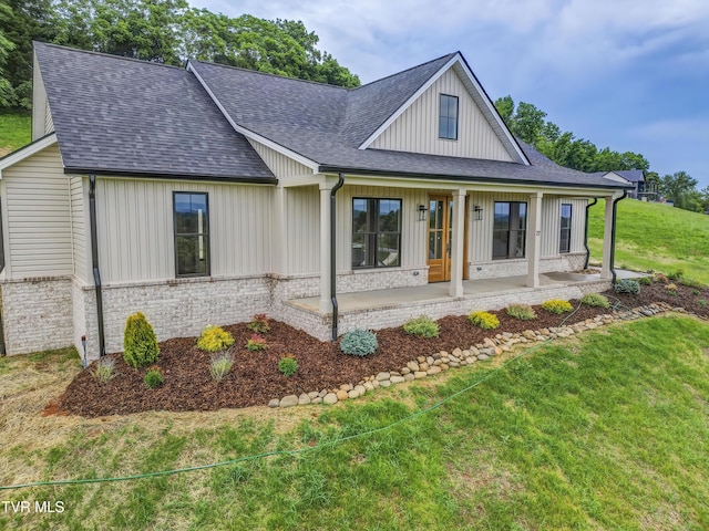 77 Sunset Rd, Johnson City, TN 37615 - modern farmhouse style home with a shingled roof, a front lawn, brick siding, and board and batten siding