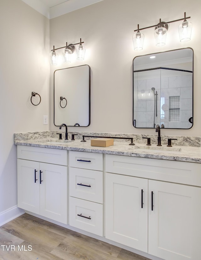 77 Sunset Rd, Johnson City, TN 37615 - bathroom with double vanity, wood finished floors, and tiled shower