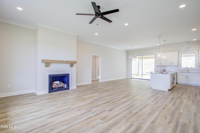 77 Sunset Rd, Johnson City, TN 37615 - unfurnished living room with ornamental molding, recessed lighting, a fireplace, ceiling fan, and light wood-style floors
