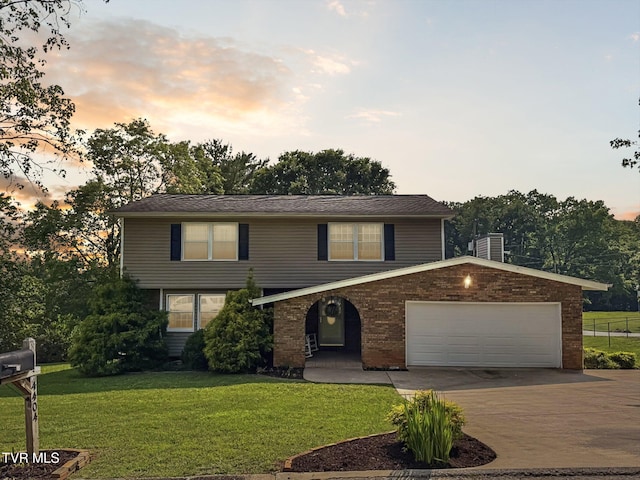 4404 Stillwood Ave, Kingsport, TN 37664 - view of front of property featuring driveway, a front lawn, an attached garage, and brick siding