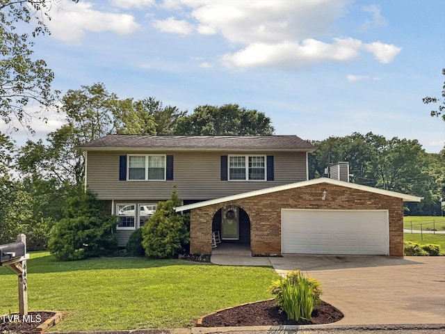 4404 Stillwood Ave, Kingsport, TN 37664 - view of front facade with concrete driveway, a front yard, and brick siding