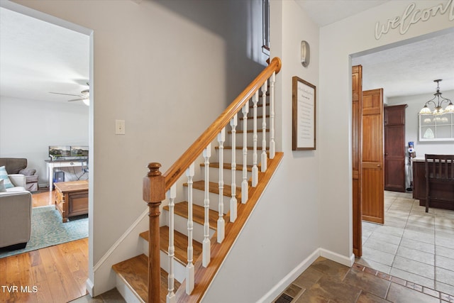 4404 Stillwood Ave, Kingsport, TN 37664 - stairs featuring ceiling fan and a chandelier