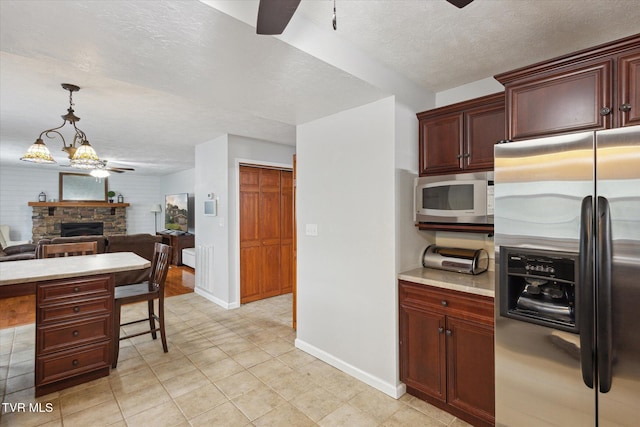 4404 Stillwood Ave, Kingsport, TN 37664 - kitchen featuring stainless steel fridge with ice dispenser, white microwave, a ceiling fan, light countertops, and a fireplace