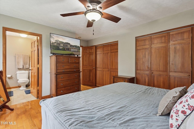 4404 Stillwood Ave, Kingsport, TN 37664 - bedroom with light wood-type flooring, multiple closets, ensuite bathroom, and ceiling fan