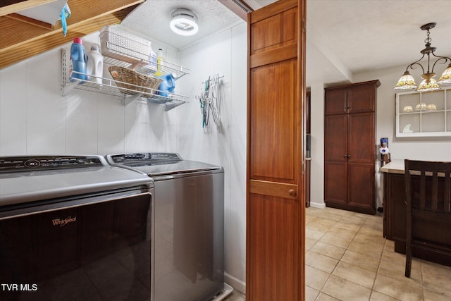 4404 Stillwood Ave, Kingsport, TN 37664 - laundry area featuring washer and dryer, light tile patterned flooring, and a chandelier