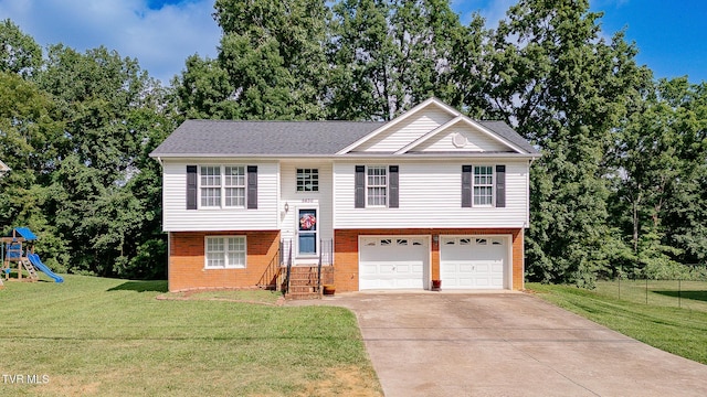 5630 Orebank Rd, Kingsport, TN 37664 - bi-level home with an attached garage, concrete driveway, brick siding, a playground, and view of wooded area