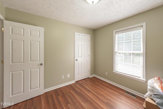 5630 Orebank Rd, Kingsport, TN 37664 - unfurnished bedroom featuring wood finished floors, a textured ceiling, and a closet