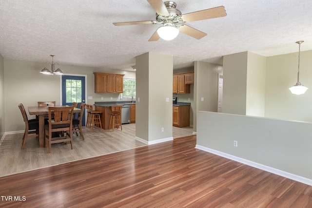 5630 Orebank Rd, Kingsport, TN 37664 - dining area with light wood-type flooring, a textured ceiling, a chandelier, and a ceiling fan
