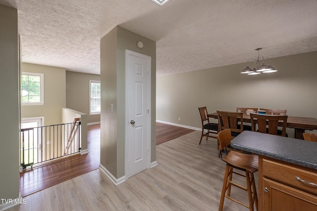 5630 Orebank Rd, Kingsport, TN 37664 - dining area with a textured ceiling, light wood-type flooring, and a chandelier