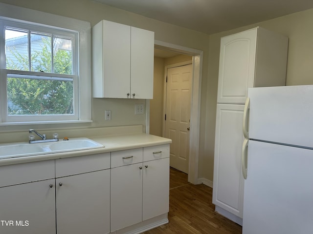 613 Spruce St, Johnson City, TN 37601 - kitchen with freestanding refrigerator, white cabinetry, wood finished floors, and light countertops