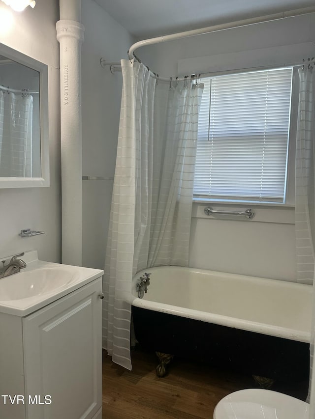 613 Spruce St, Johnson City, TN 37601 - full bath with wood finished floors, vanity, and shower / bath combination with curtain