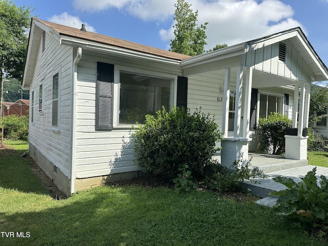 613 Spruce St, Johnson City, TN 37601 - view of property exterior featuring a lawn, covered porch, and board and batten siding
