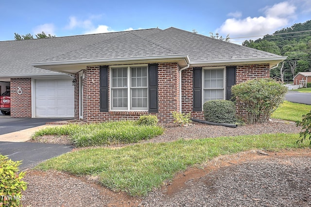 2425 E Lakeview Dr Unit 1, Johnson City, TN 37601 - view of front of property featuring brick siding, roof with shingles, an attached garage, and driveway