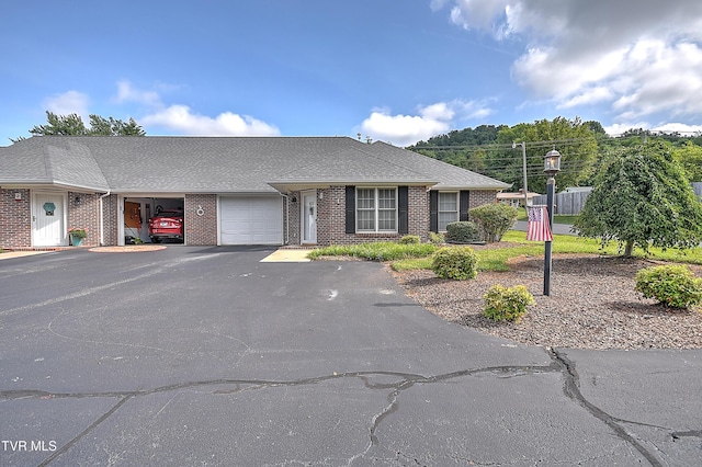 2425 E Lakeview Dr Unit 1, Johnson City, TN 37601 - townhome / multi-family property with an attached garage, asphalt driveway, brick siding, and roof with shingles