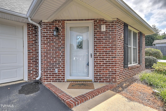 2425 E Lakeview Dr Unit 1, Johnson City, TN 37601 - view of exterior entry featuring brick siding, a garage, and asphalt driveway