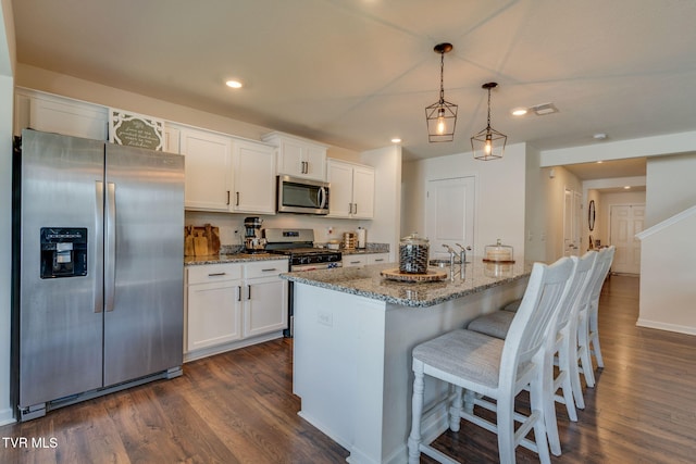 1244 Stamp Lodge Rd, Kingsport, TN 37660 - kitchen with appliances with stainless steel finishes, dark wood-style flooring, white cabinetry, light stone countertops, and recessed lighting