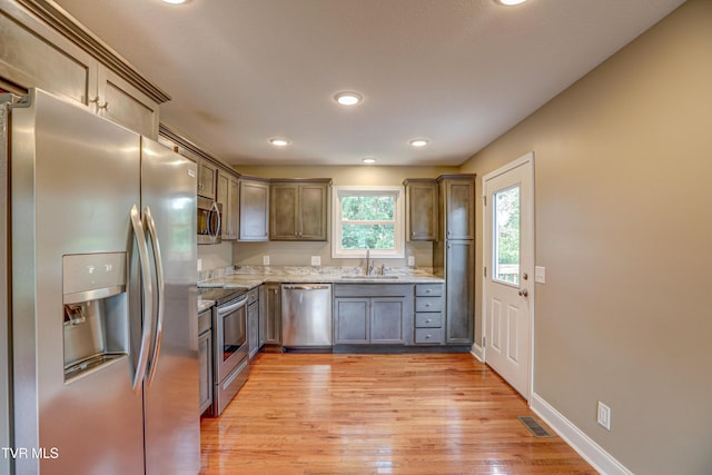 136 W Wilkshire Pl, Bristol, TN 37620 - kitchen with appliances with stainless steel finishes, light wood finished floors, light stone countertops, and recessed lighting