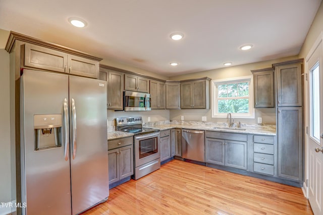 136 W Wilkshire Pl, Bristol, TN 37620 - kitchen with appliances with stainless steel finishes, light stone countertops, light wood-style flooring, and recessed lighting