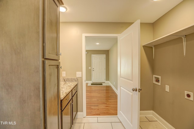 136 W Wilkshire Pl, Bristol, TN 37620 - washroom featuring electric dryer hookup, cabinet space, washer hookup, and light tile patterned floors