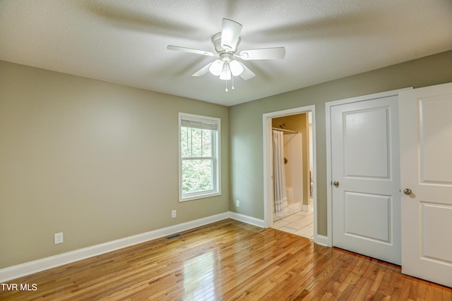 136 W Wilkshire Pl, Bristol, TN 37620 - unfurnished bedroom featuring light wood finished floors, ensuite bathroom, and a ceiling fan