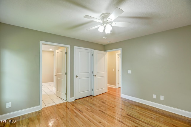 136 W Wilkshire Pl, Bristol, TN 37620 - unfurnished bedroom with light wood-style flooring, ceiling fan, and ensuite bathroom