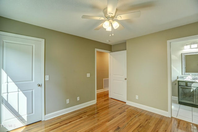 136 W Wilkshire Pl, Bristol, TN 37620 - unfurnished bedroom featuring light wood-style flooring, ensuite bath, and ceiling fan