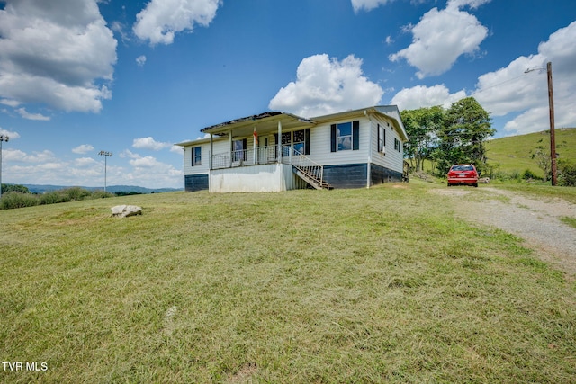 212 Circle, Castlewood, VA 24224 - view of front of home featuring stairs, driveway, a porch, and a front lawn