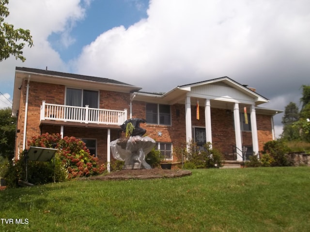 313 Milburn Ave, Kingsport, TN 37660 - neoclassical home featuring brick siding, a front yard, and a balcony