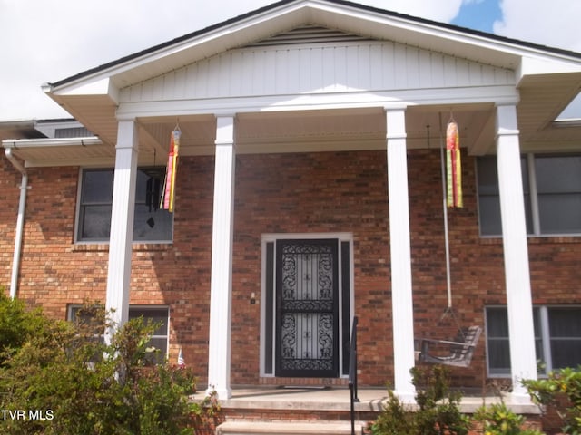 313 Milburn Ave, Kingsport, TN 37660 - view of exterior entry with a porch and brick siding