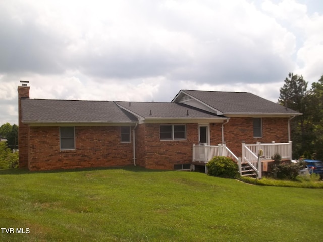 313 Milburn Ave, Kingsport, TN 37660 - back of property with a chimney, a yard, a deck, and brick siding