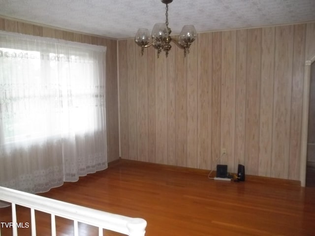 313 Milburn Ave, Kingsport, TN 37660 - unfurnished dining area with wood finished floors, a chandelier, and wood walls
