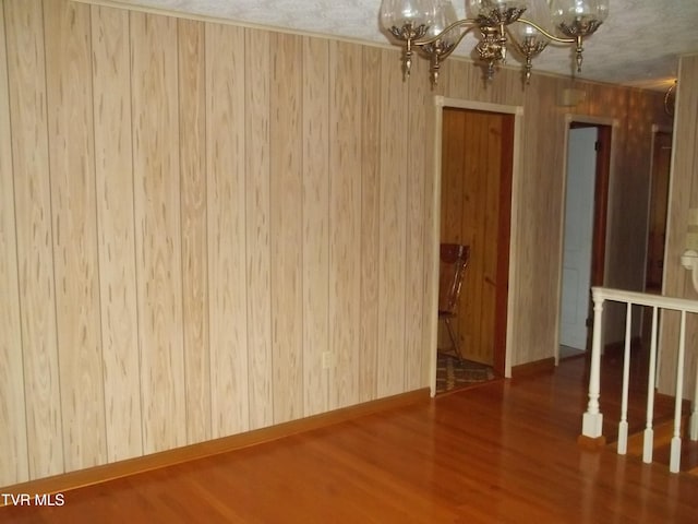 313 Milburn Ave, Kingsport, TN 37660 - empty room featuring a chandelier, wood finished floors, and wooden walls